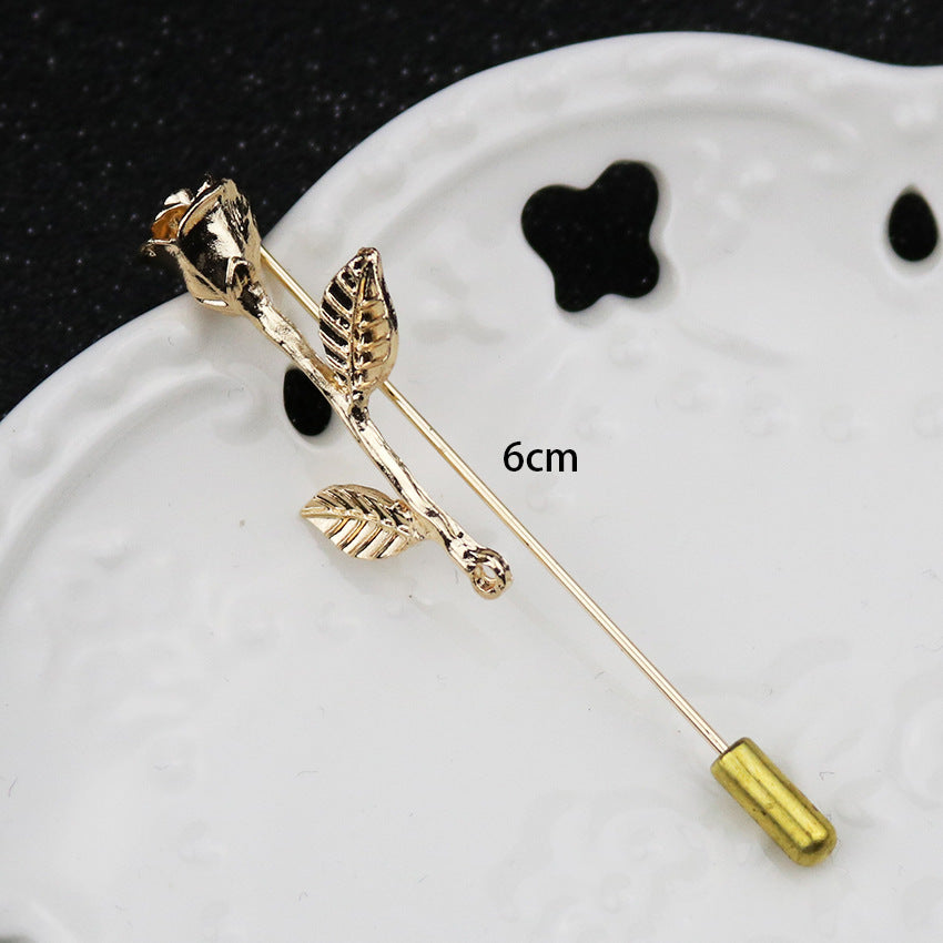 6 cm long-pin lapel brooch with anchor and flower motifs, gold-tone with rhinestones