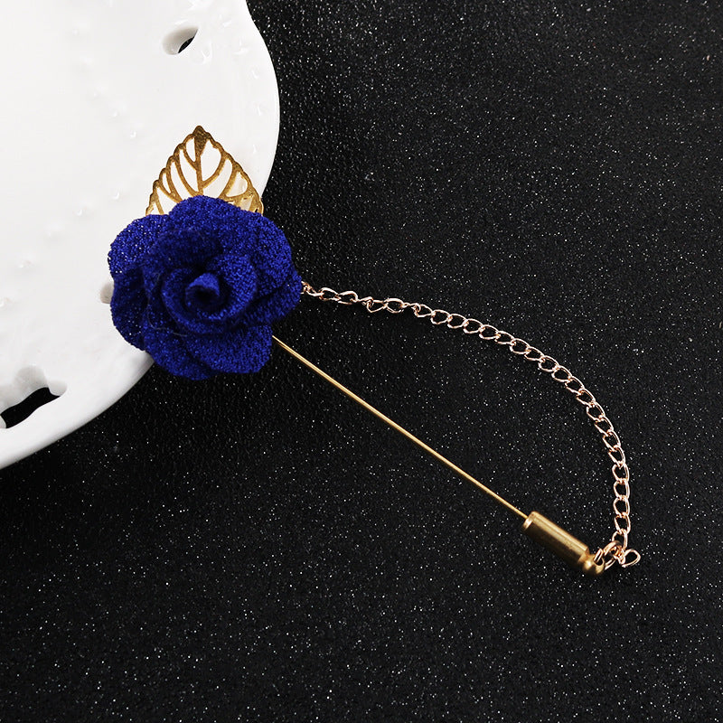 Blue flower leaf brooch pin with gold chain and bar clasp, close-up