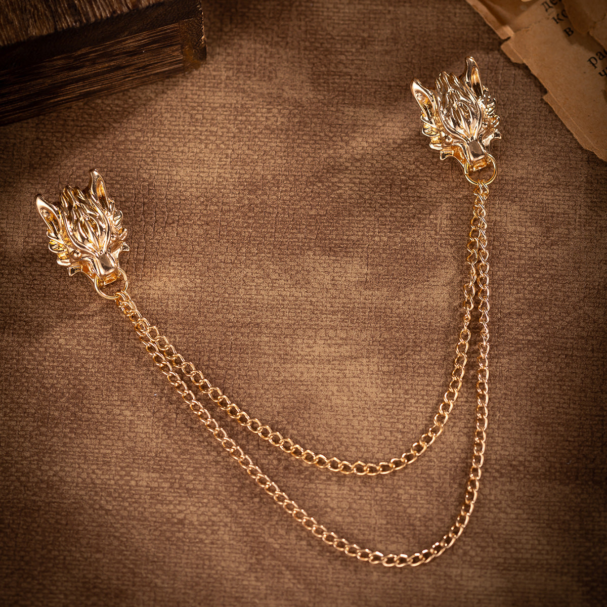 Gold wolf head chain lapel brooch with draped double linked chains