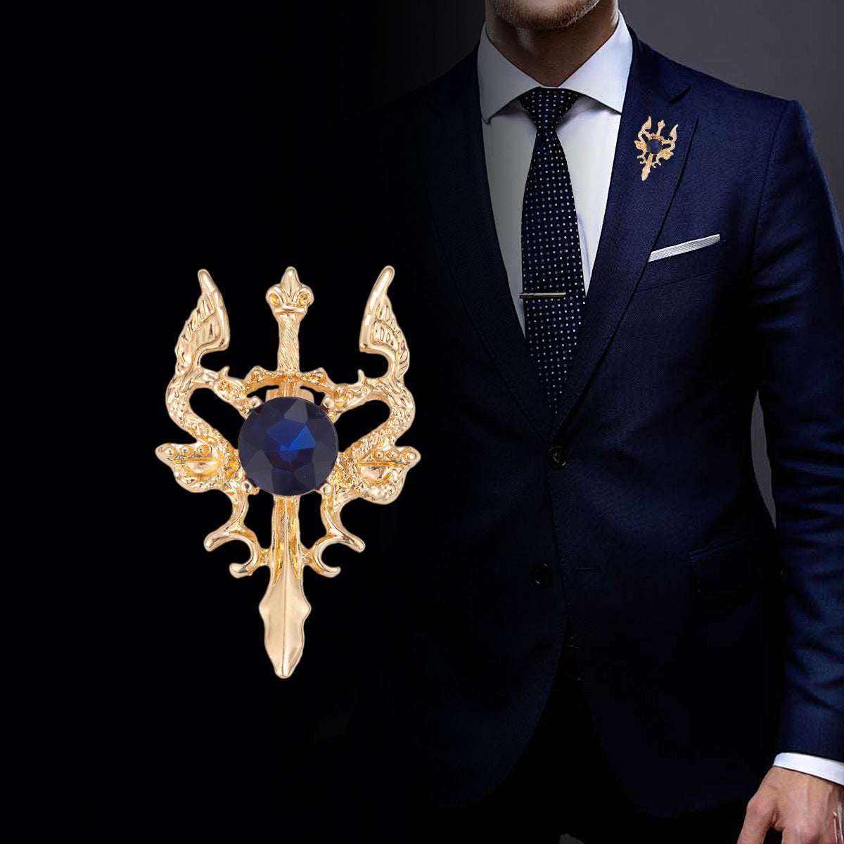 Gold double dragon sword brooch with dark blue round gemstone on suit lapel