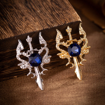 Silver double dragon sword brooch with dark blue round gemstone center