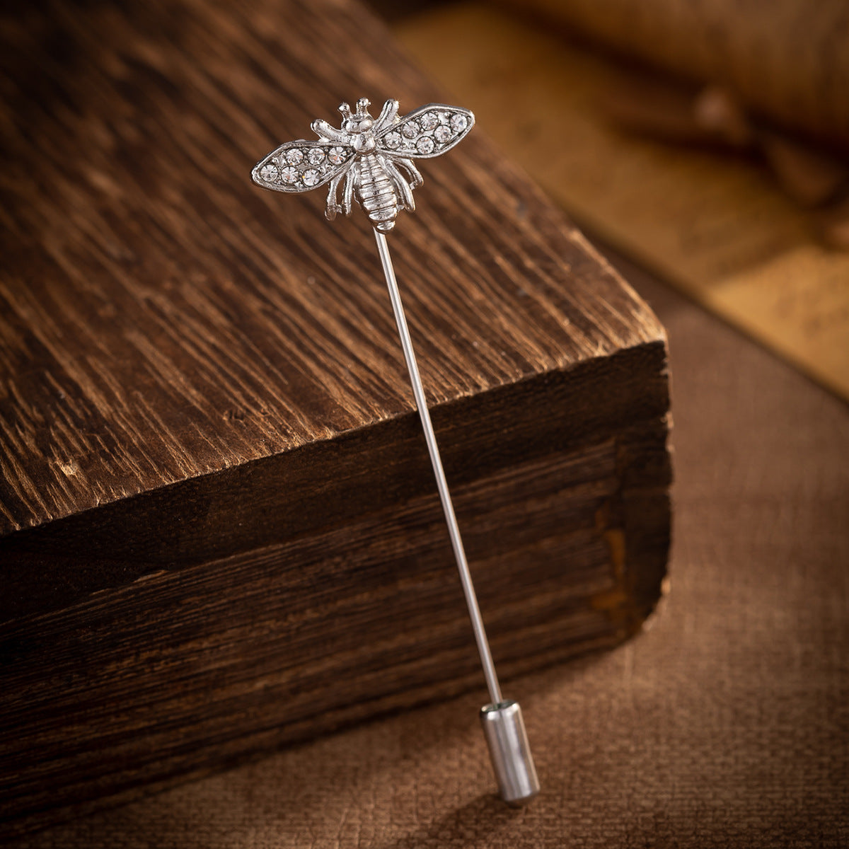 Silver-tone bee brooch pin with sparkling rhinestone wings and hinged clasp