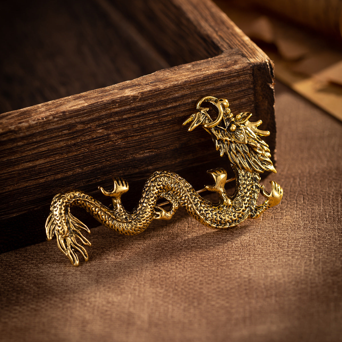 Antique gold dragon zodiac totem brooch with raised claws and scale texture