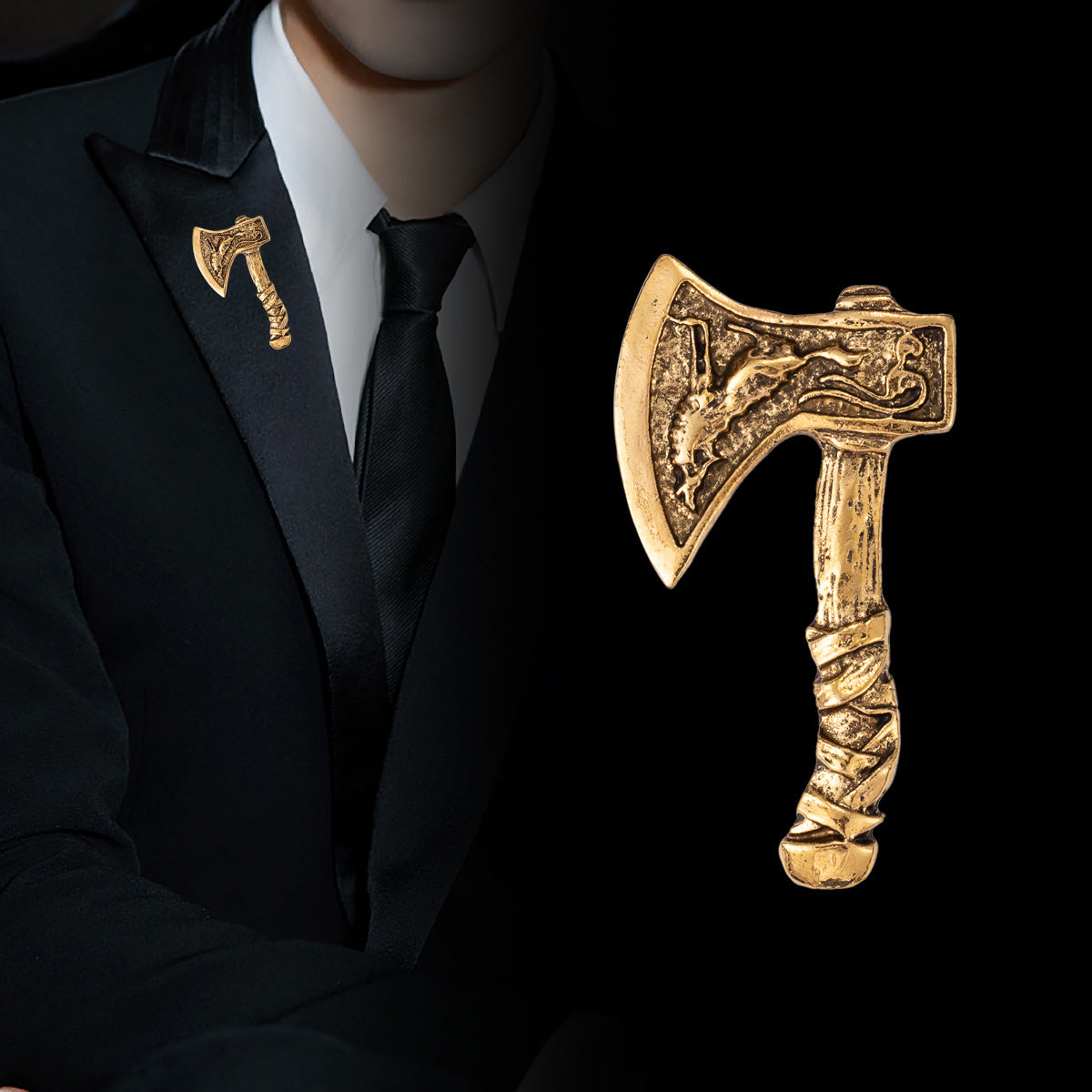 Axe brooch in antique gold, pinned on a dark suit lapel