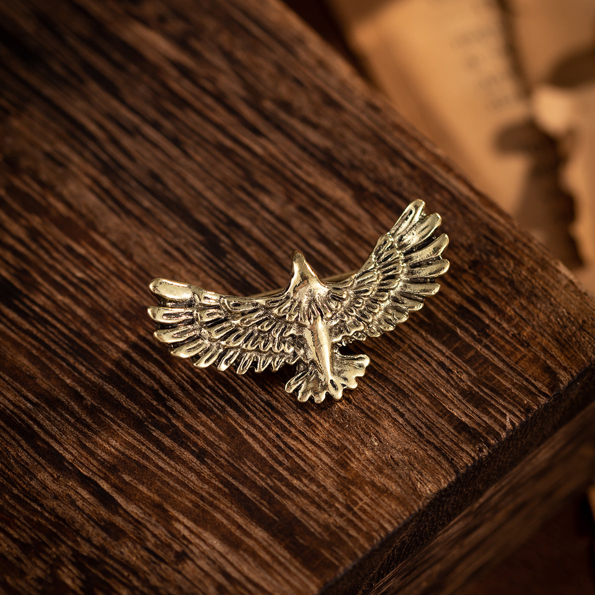 Gold-tone eagle badge brooch, detailed feather wings and pointed beak