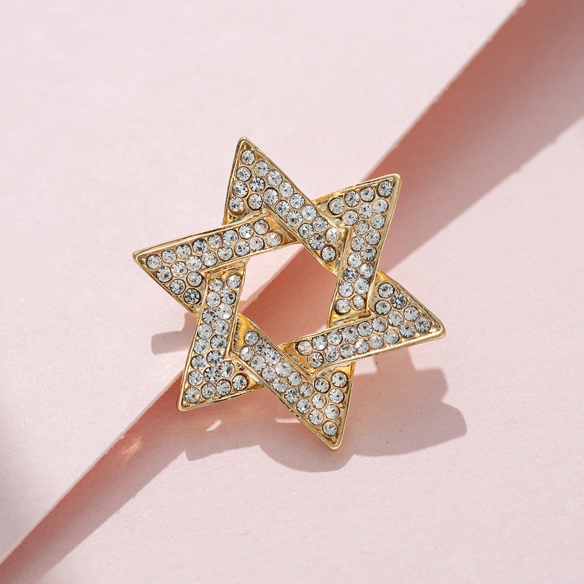 Gold six-point rhinestone star pin with open center