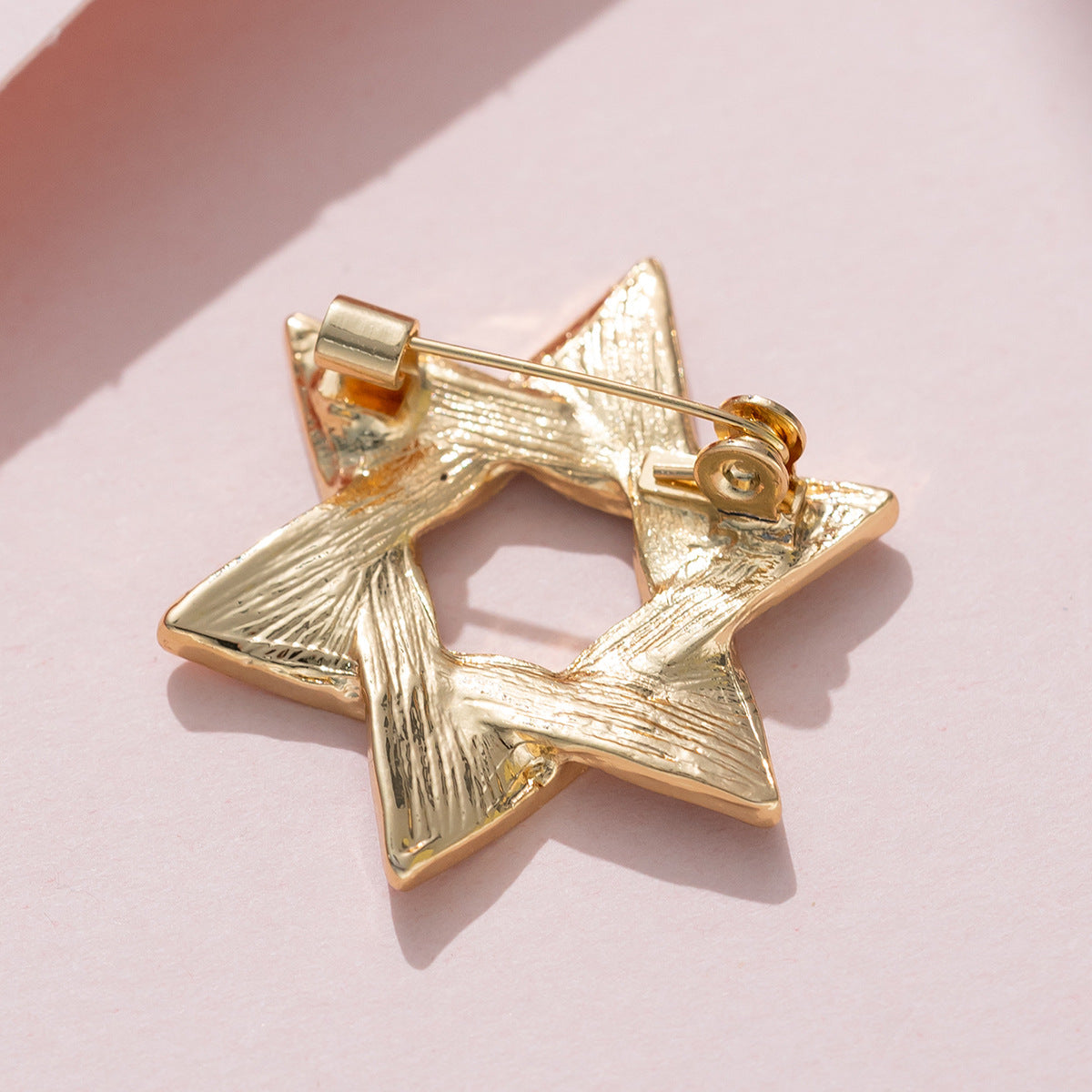 Gold six-point star brooch back with clasp and straight pin