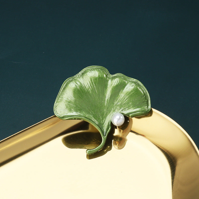 Green 3D leaf brooch pin with one large leaf and a small white pearl
