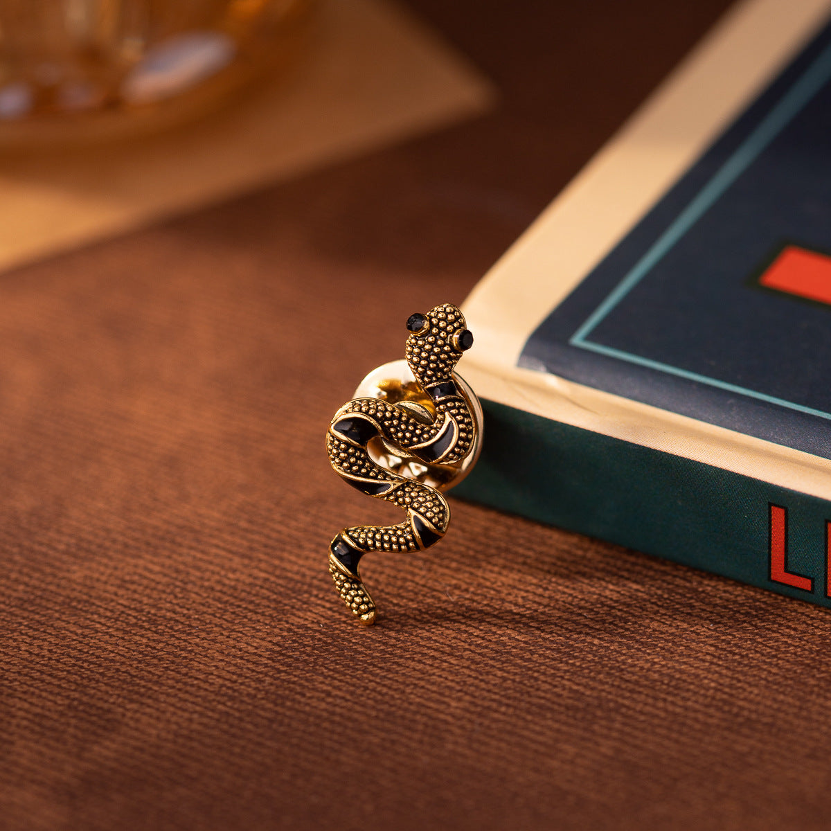Gold mini snake brooch pin, coiled shape with dark details