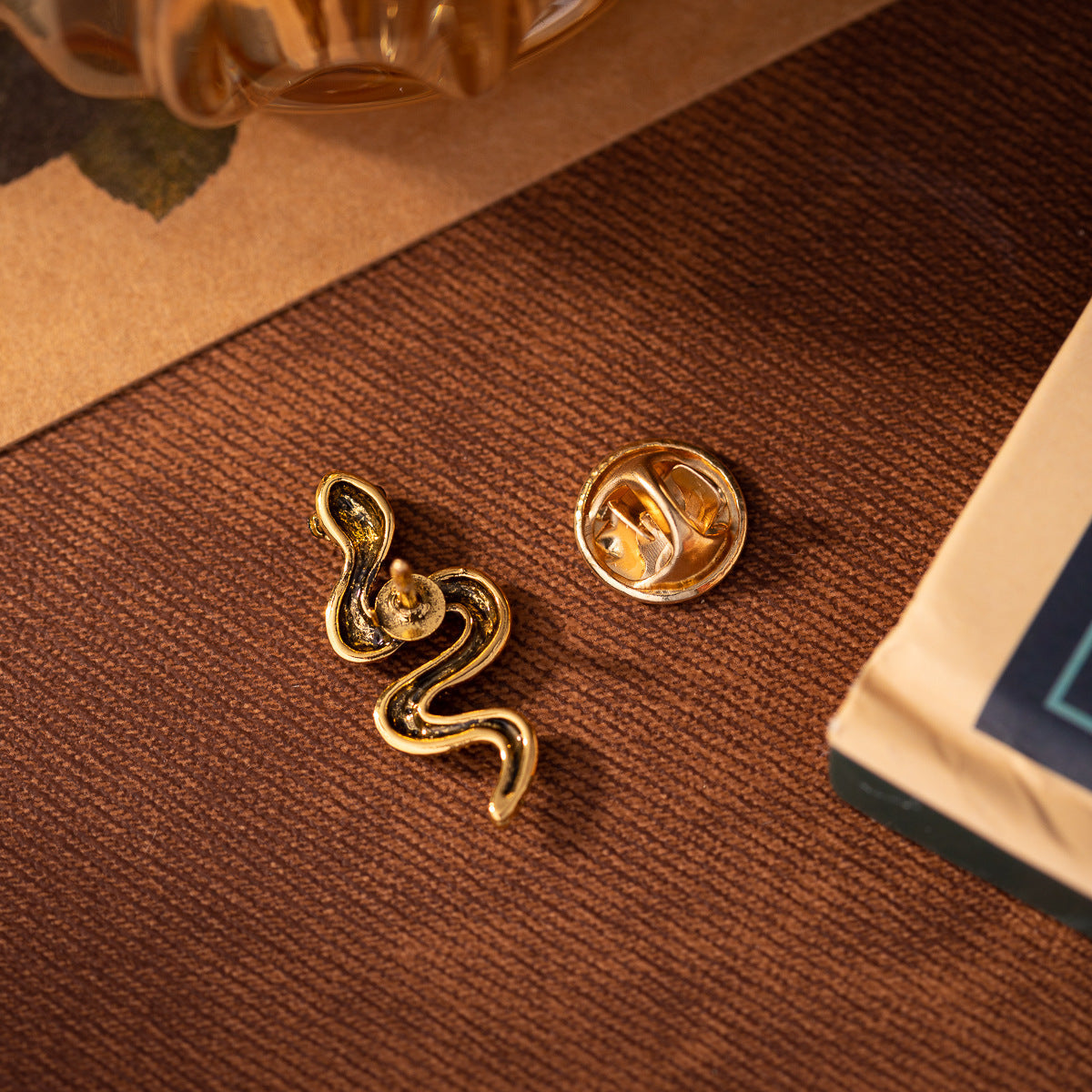 Mini silver snake brooch pin with textured scales, curved body