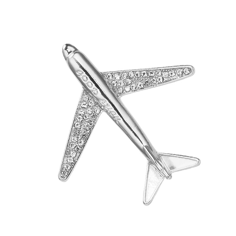 Silver airplane brooch pin with clear rhinestone detail across the body and wings