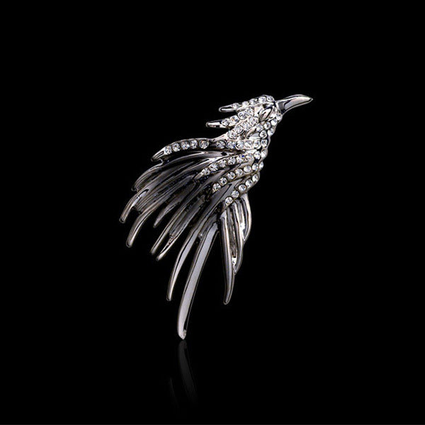 Silver eagle metal brooch badge with rhinestone-studded wings and curved pin