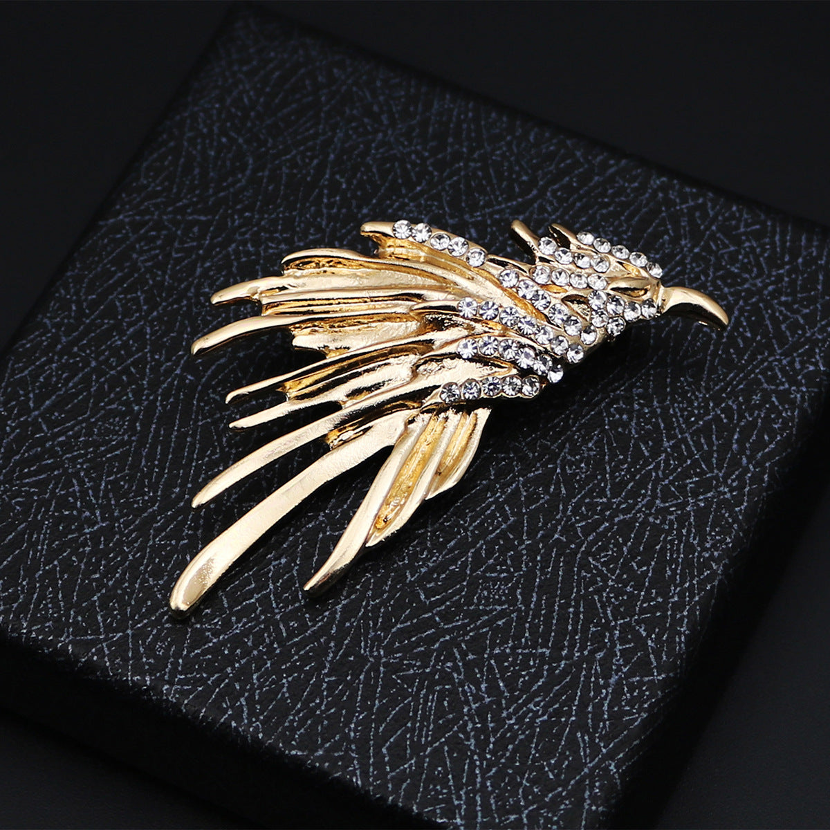 Gold eagle metal brooch badge with rhinestone accents, feather-like wing design
