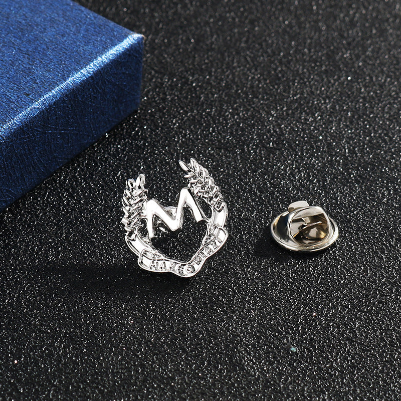 Silver-tone M wheat ear brooch with safety pin backing and clasp