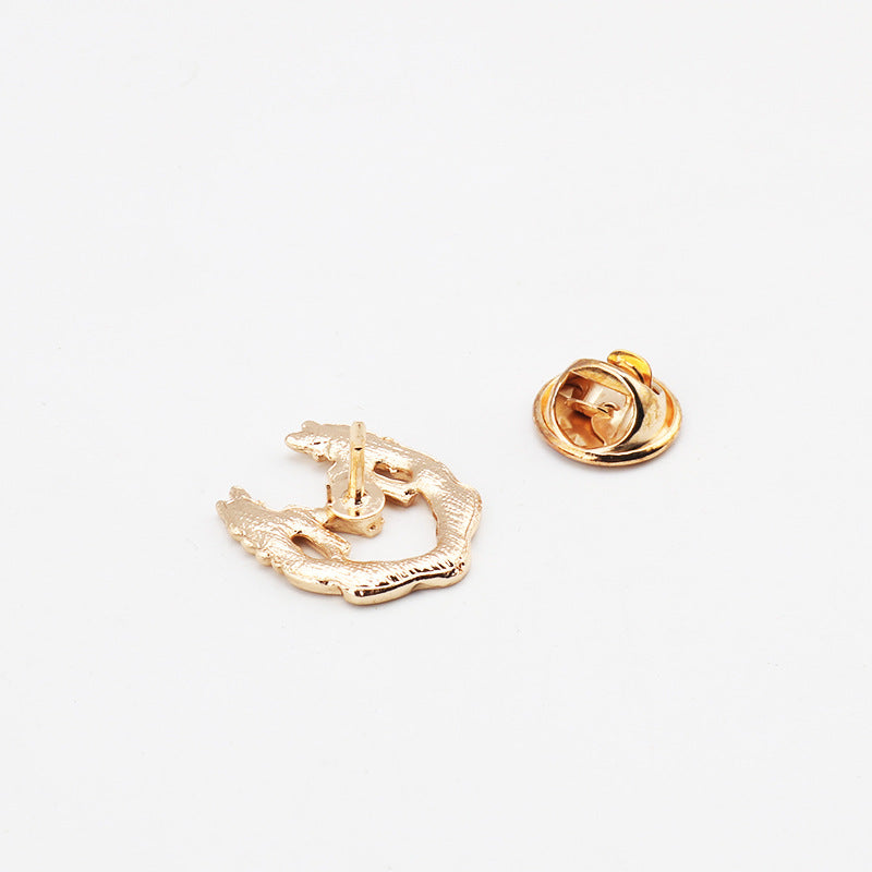 Gold M brooch back with safety pin and hinge closure