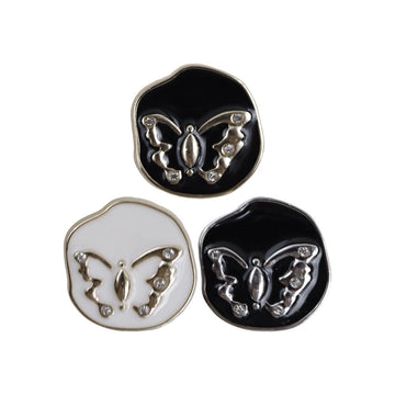 Irregular metal shank buttons: black base with silver butterfly, plus white with gold butterfly