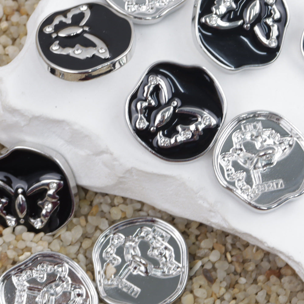 Metal shank buttons, butterfly pattern with shiny silver details on dark bases