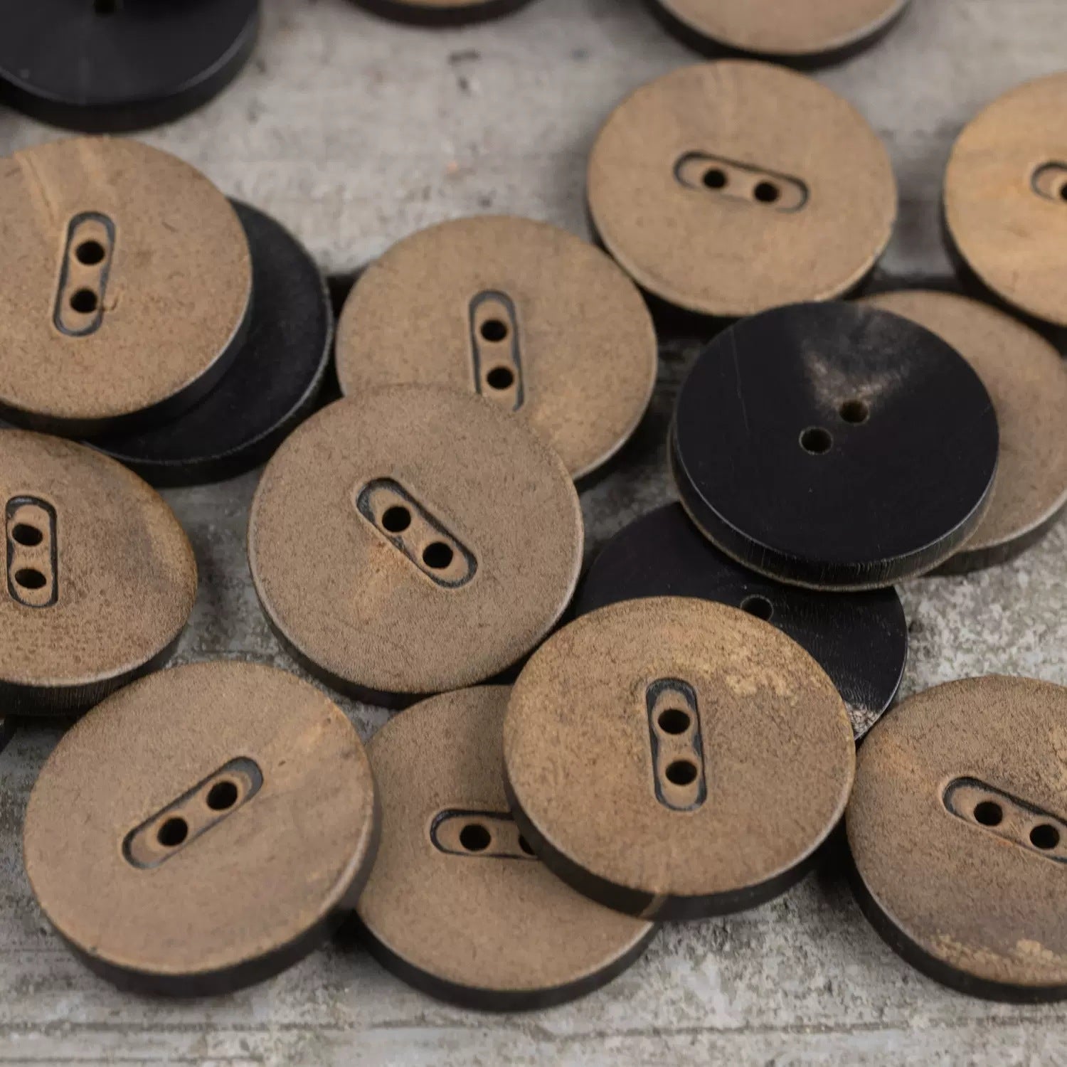 Round fire-burnished horn buttons, tan with 2-hole oval slots