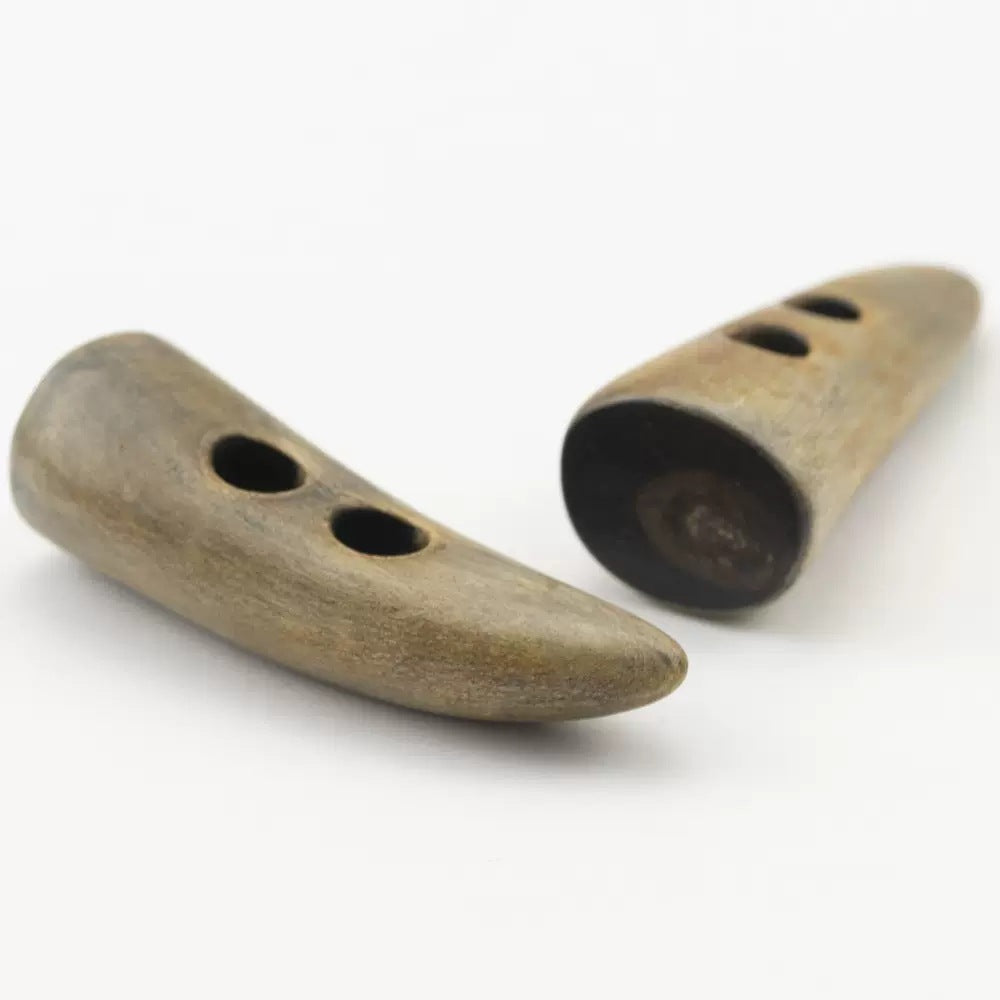 Horn-look toggle button pair, side view, burnt tan with two top holes