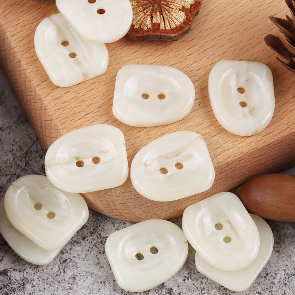 25mm off-white nail-shaped resin buttons with two holes, glossy