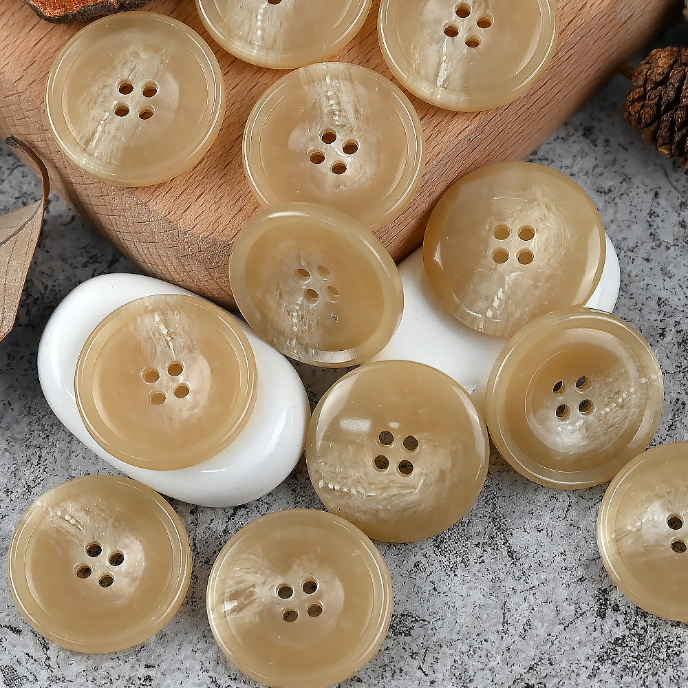 Round 4-hole urea buttons in beige, light tan, and cream tones mix