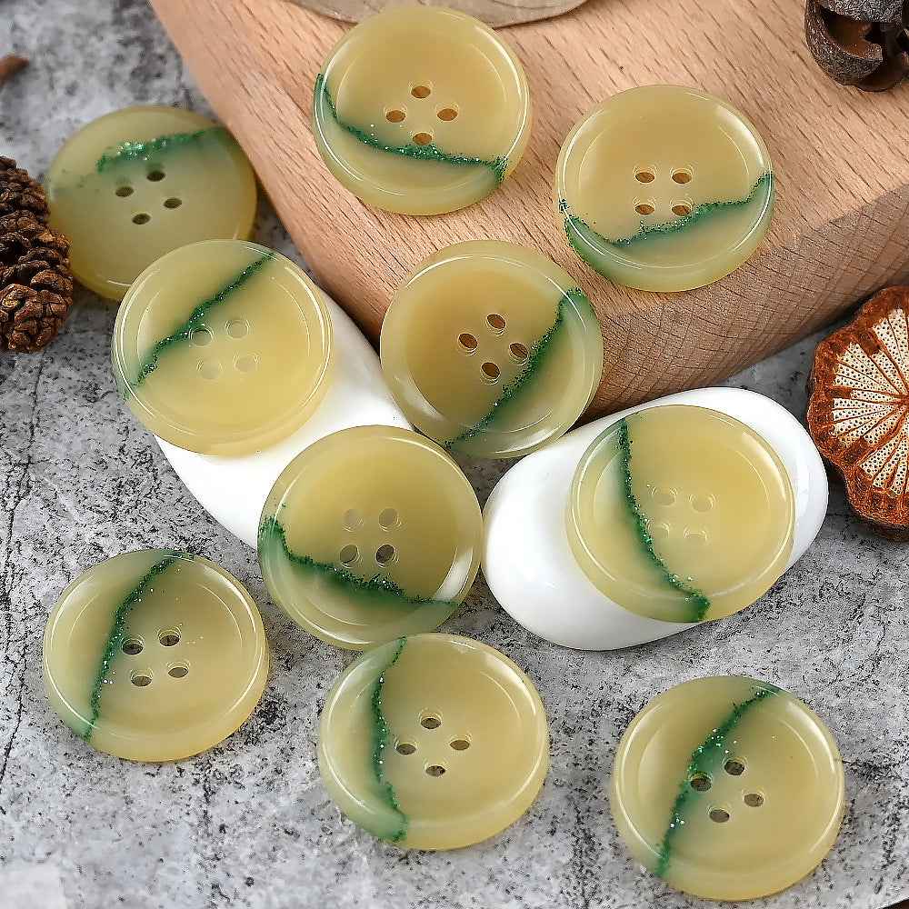 Round 4-hole urea buttons in yellow-green with darker green streak detail