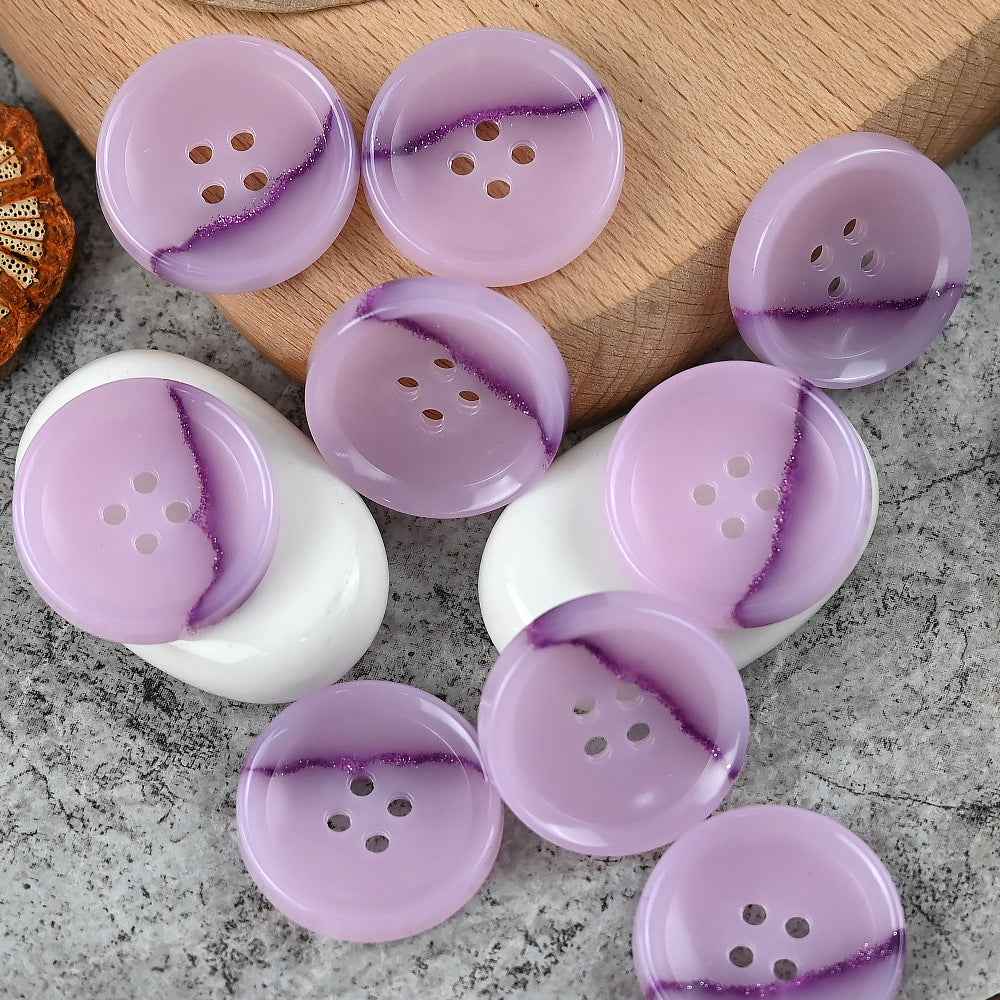 Round 4-hole urea buttons in purple with darker purple streak detail