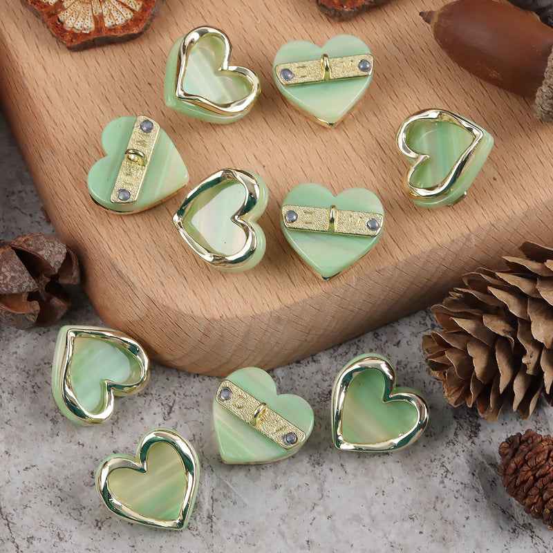 Heart-shaped resin metal shank buttons, mint green faces with shiny chrome edges