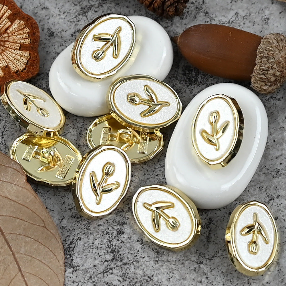Gold-tone tulip oval metal shank buttons, multiple emblems on white oval bases