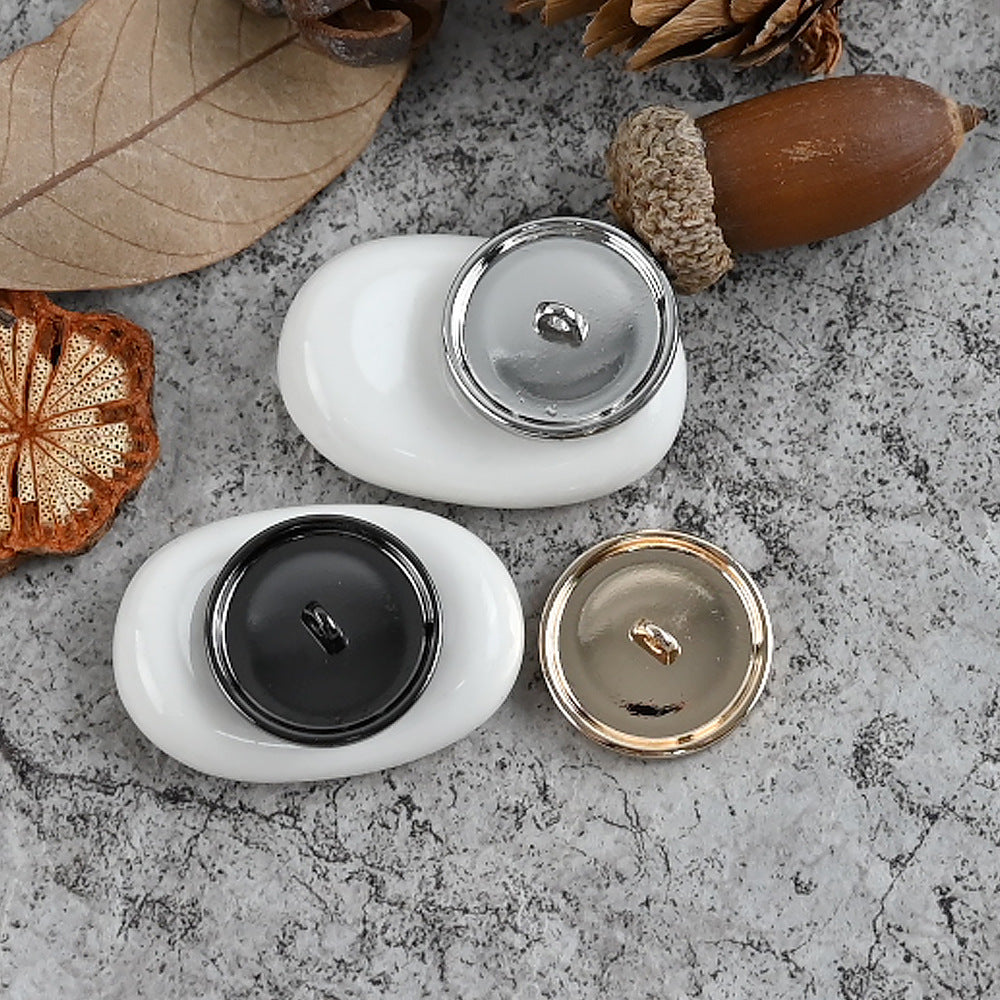 Black and silver metal shank buttons with smooth dark and reflective backs
