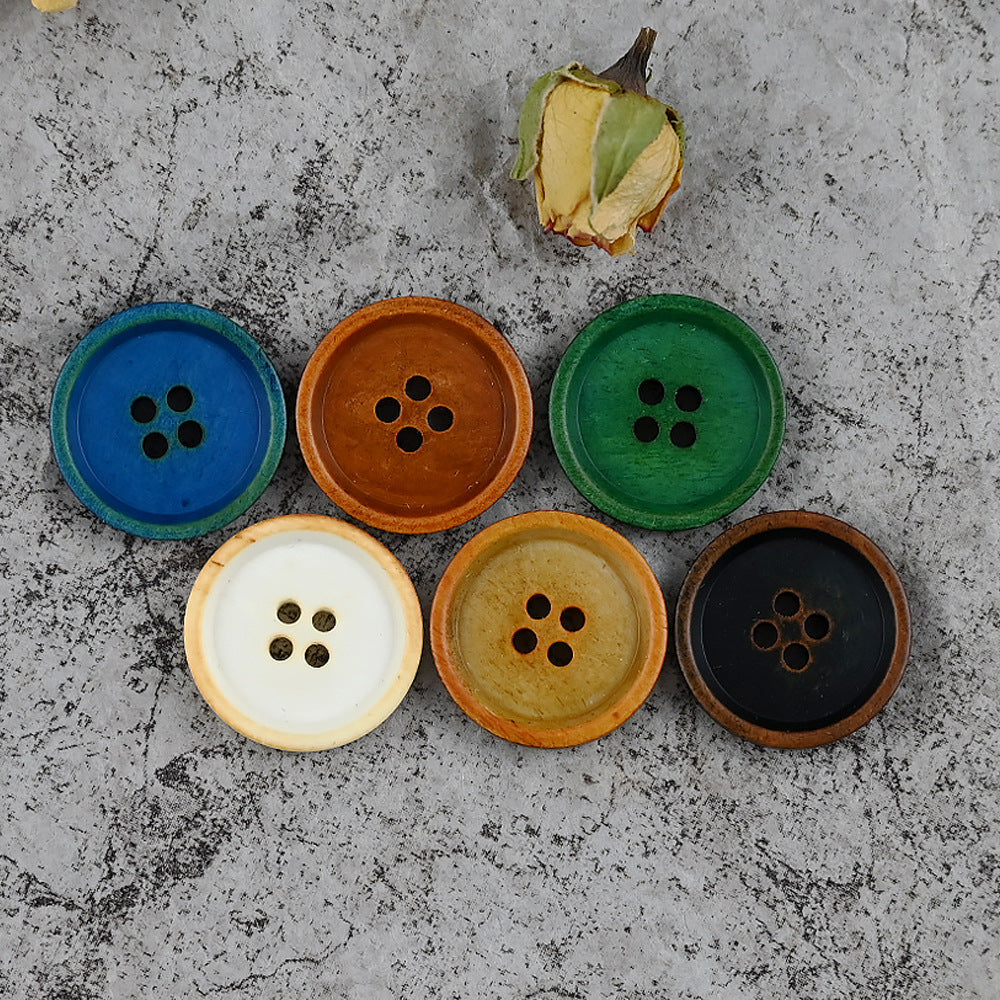 Set of round 4-hole cow bone buttons in blue, brown, green, and cream