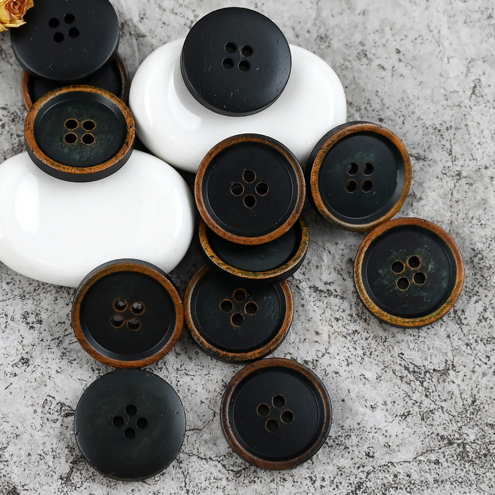 Black round 4-hole cow bone buttons with warm brown rim, multiple pieces
