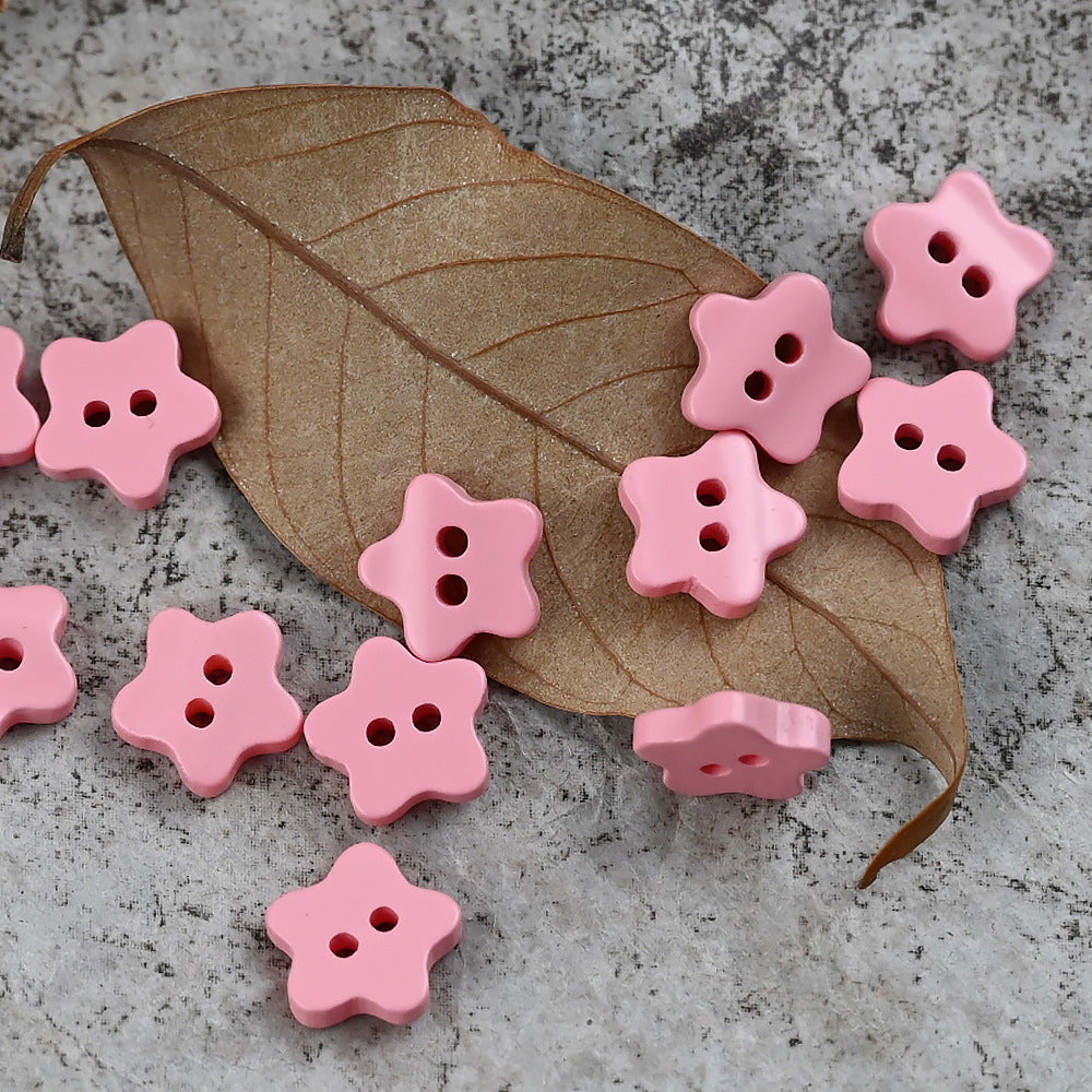 Pink star-shaped delicate buttons with four holes