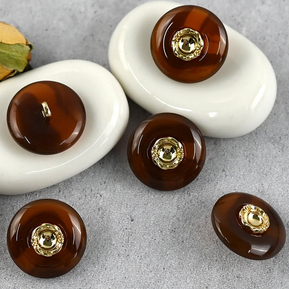 Brown resin buttons with gold-tone metal shanks and round gold center cap