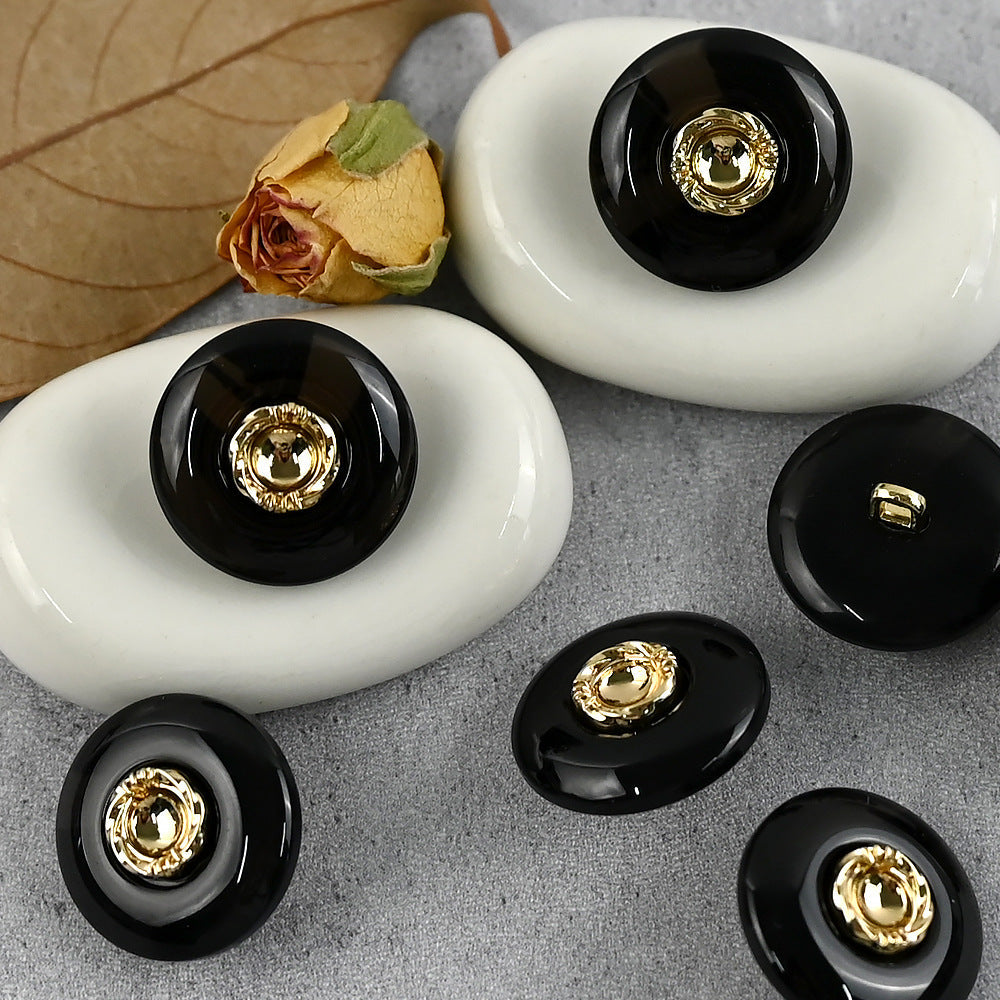 Black resin buttons with gold-tone metal shanks and round gold center cap