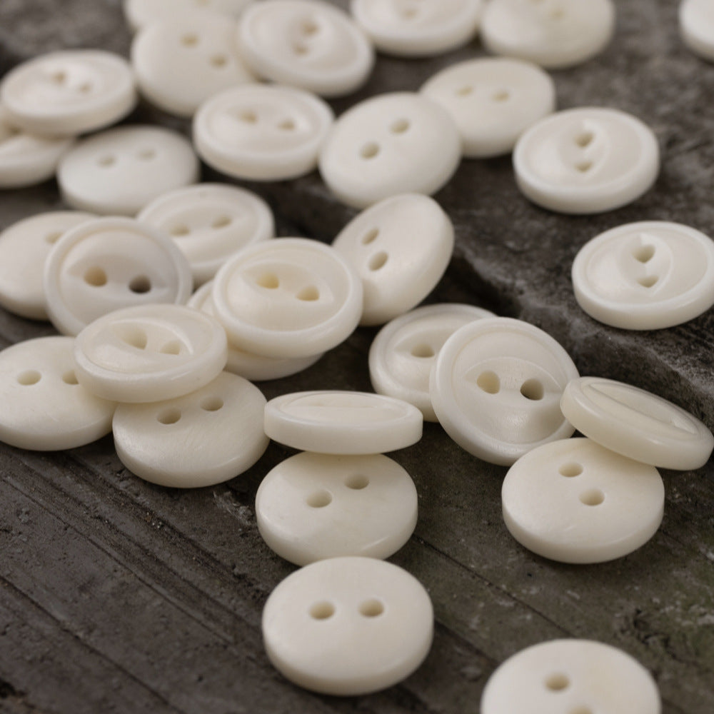 Ivory 11.5mm round two-hole fish-eye buttons, assorted pieces