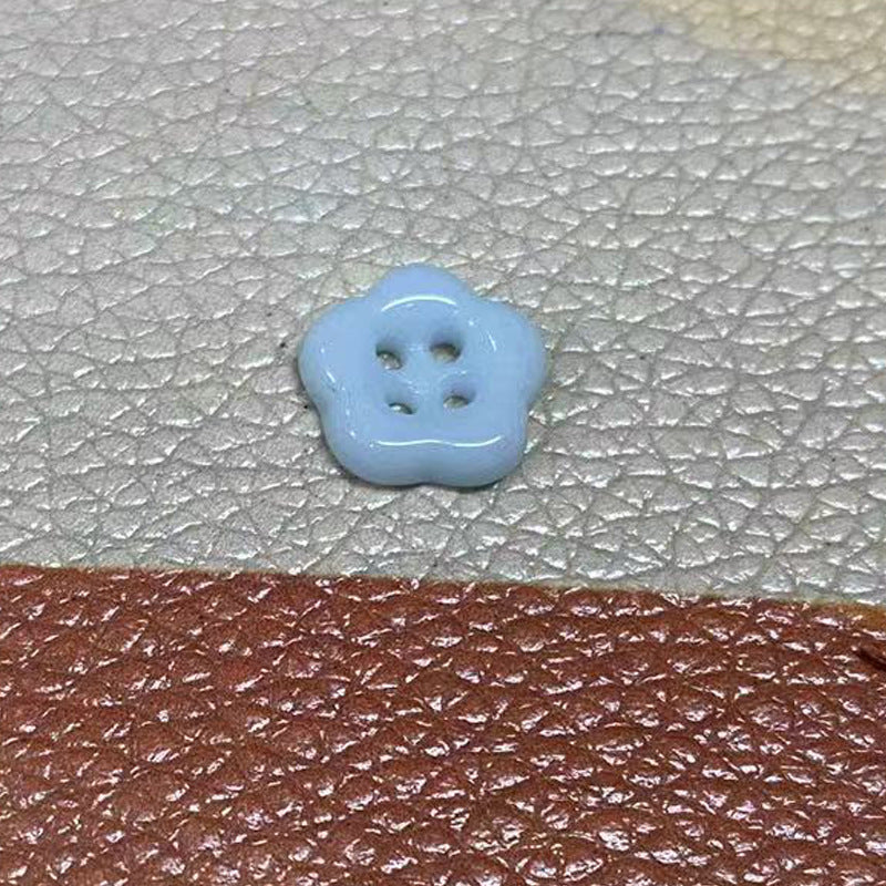 Light blue flower-shaped ceramic clothing button, 4 holes