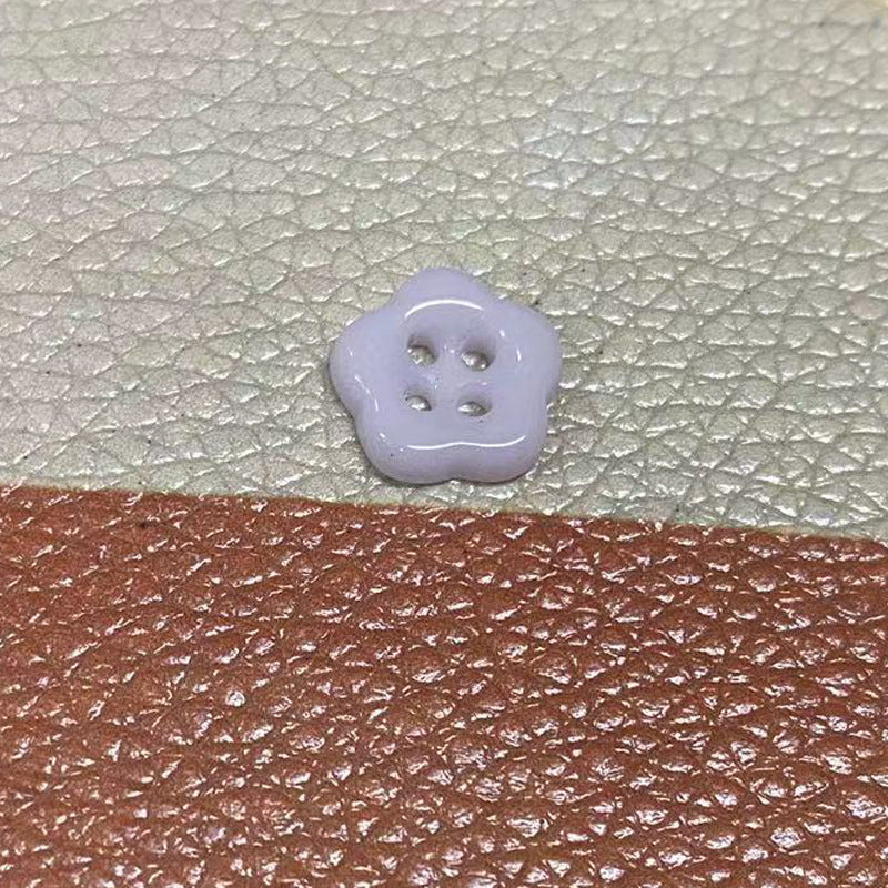 Light purple flower-shaped ceramic clothing button with 4 holes