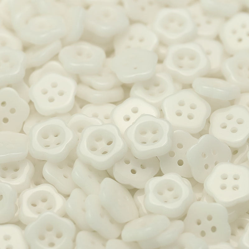 White/off-white flower-shaped ceramic buttons with four holes for kids clothing