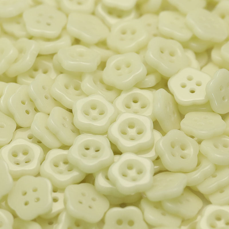 Pale yellow flower-shaped ceramic buttons with four holes for kids clothing