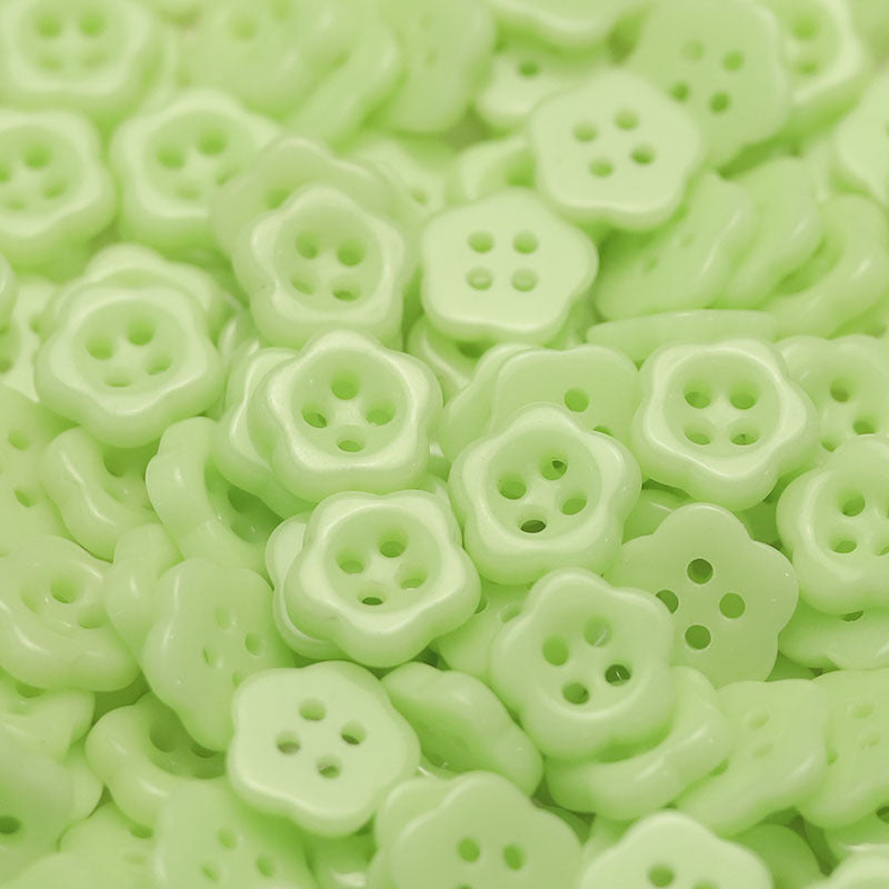 Light green flower-shaped ceramic buttons with four holes for kids clothing