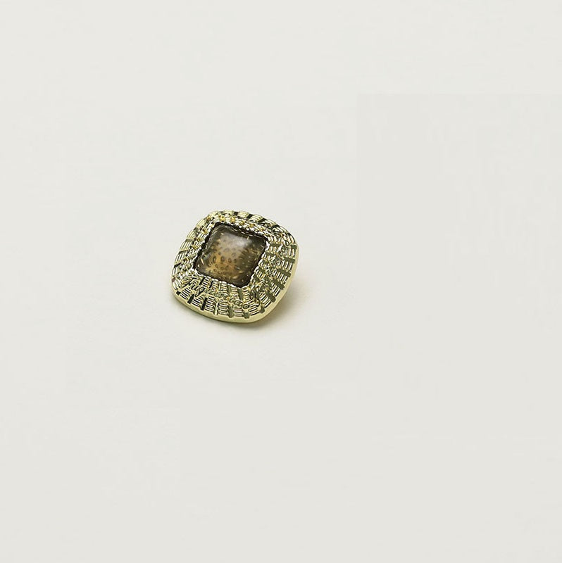 Square gold metal button with light beige square insert and ornate rim