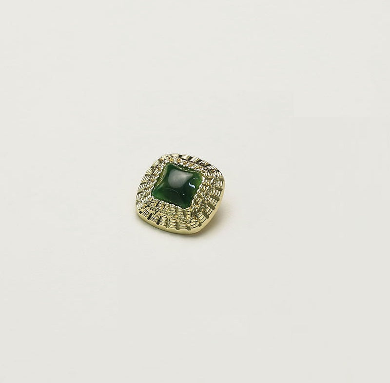 Square gold metal button with green square insert and ornate rim