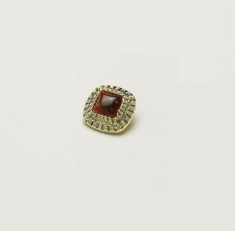 Square gold metal button with dark brown square insert and ornate rim