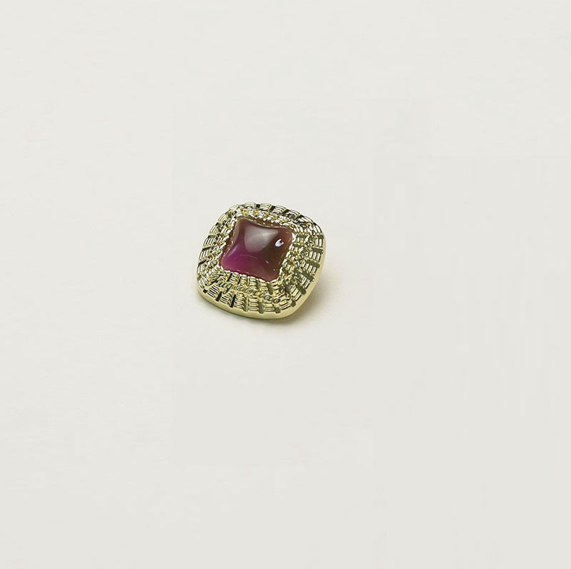 Square gold metal button with maroon square insert and ornate rim