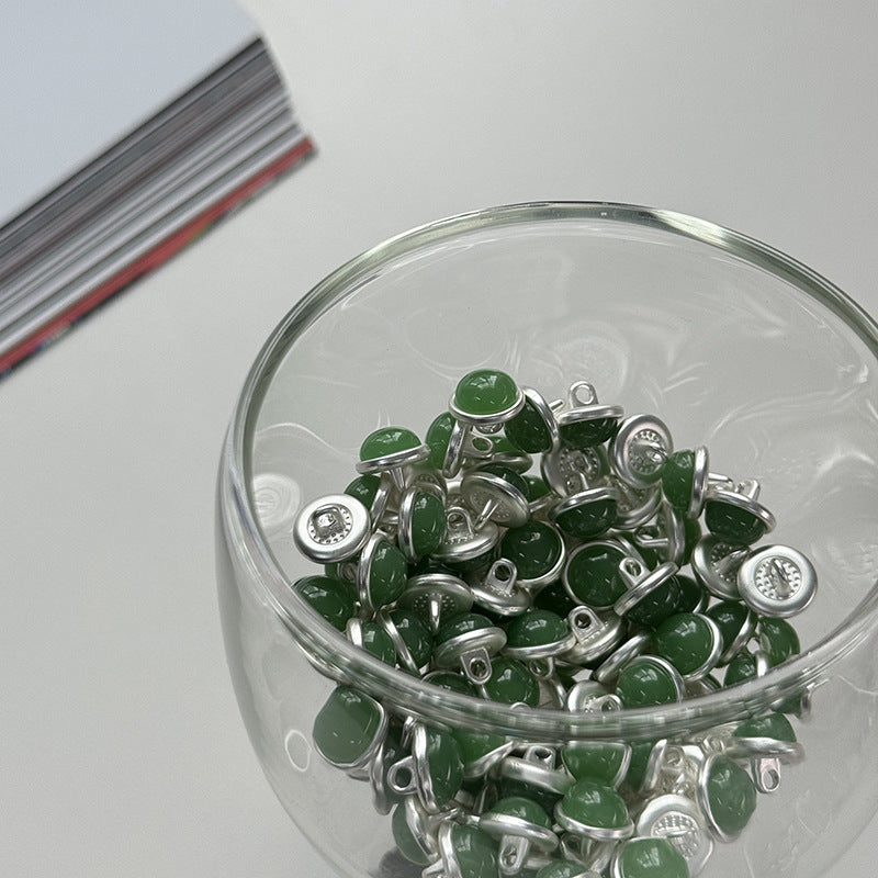 Jar of dark green jelly alloy buttons with silver shanks