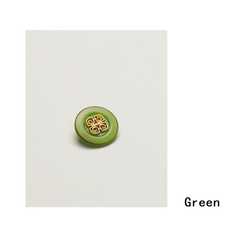 Green Chinese-style metal button with gold filigree knot detailing, round front