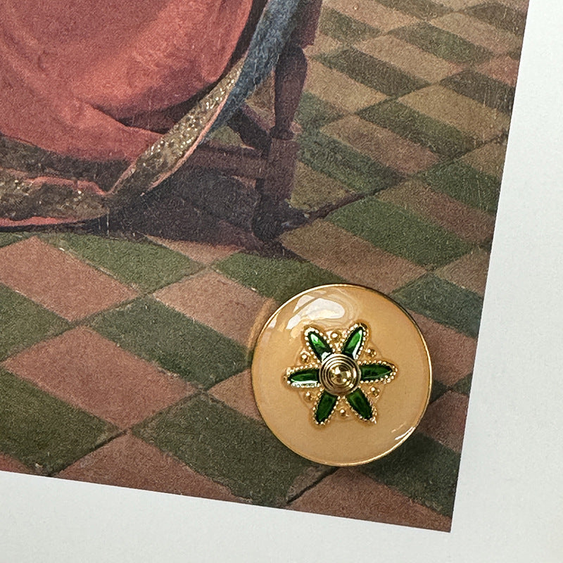 Gold alloy button with green flower star design on round face