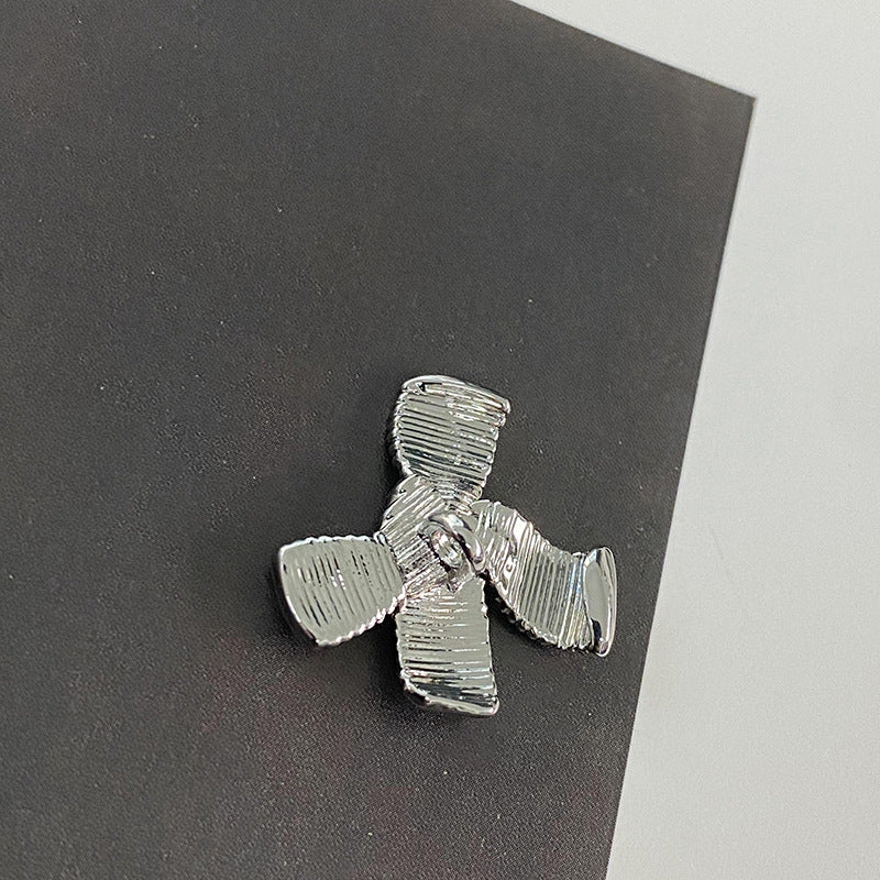 Silver striped bow metal button, ridged cross shape