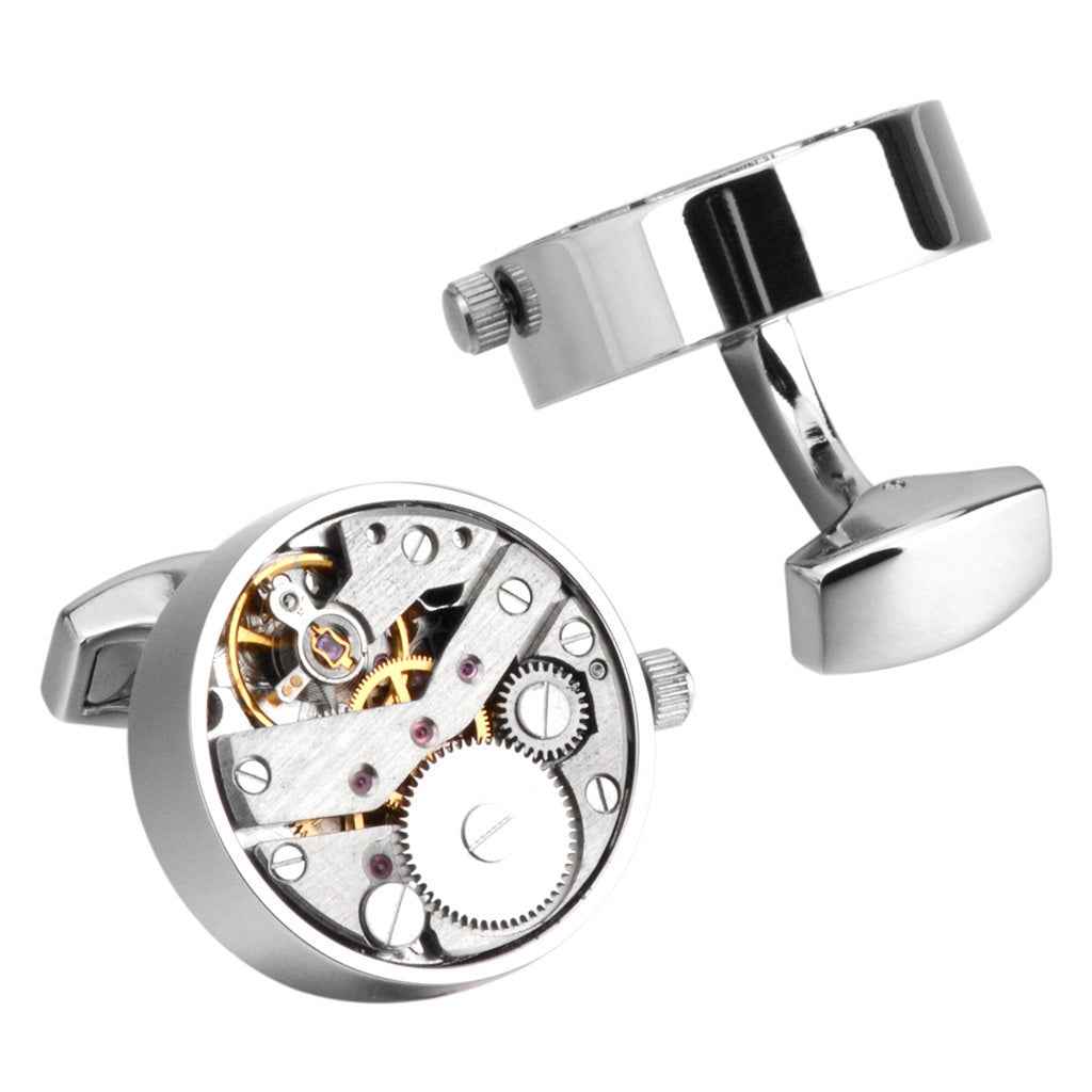 Silver mechanical watch movement cufflinks, close-up of round gear face and bar clasp